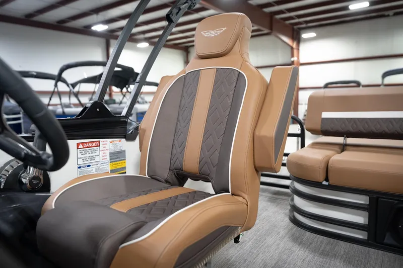 Slide: The Image of 2026 Bennington 22 MSB boat interior with luxurious brown and gray seating. - 45