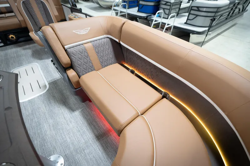 Slide: The Image of 2026 Bennington 22 MSB boat interior with luxurious tan seating and ambient lighting. - 49