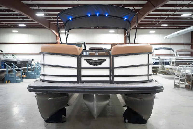 Slide: The Image of 2026 Bennington 22 MSB pontoon boat in showroom, front view with canopy. - 5