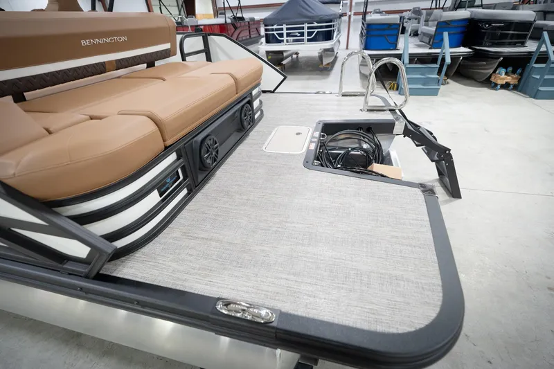 Slide: The Image of 2026 Bennington 22 MSB pontoon boat interior with tan seating and storage compartment. - 57