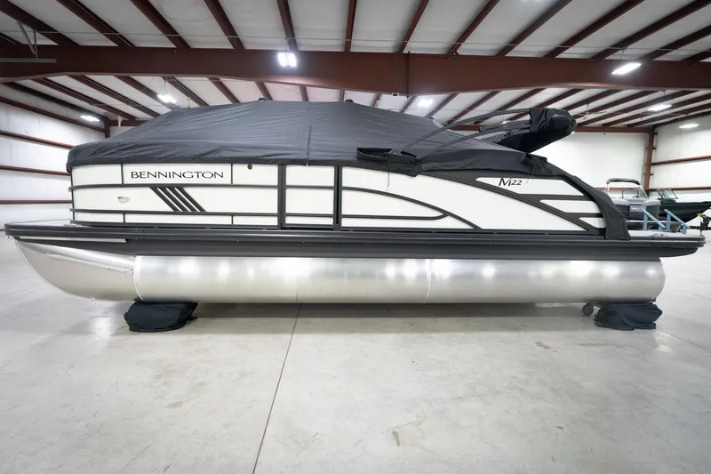 Slide: The Image of 2026 Bennington 22 MSB pontoon boat in indoor storage, covered and secured. - 58