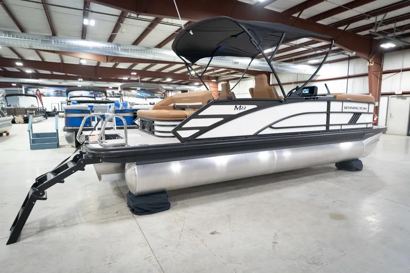Slide: The Image of 2026 Bennington 22 MSB pontoon boat in showroom, featuring sleek design and modern amenities. - 8