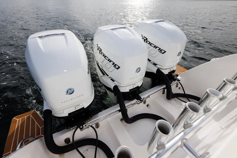 Slide: The Image of Triple outboard engines on a 2017 Intrepid 375 Nomad FE boat in water. - 30