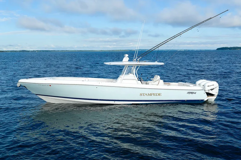 Slide: The Image of 2017 Intrepid 375 Nomad FE boat on open water, clear sky background. - 3