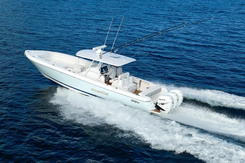 Slide: The Image of 2017 Intrepid 375 Nomad FE boat cruising on open water, showcasing sleek design and powerful engines. - 18