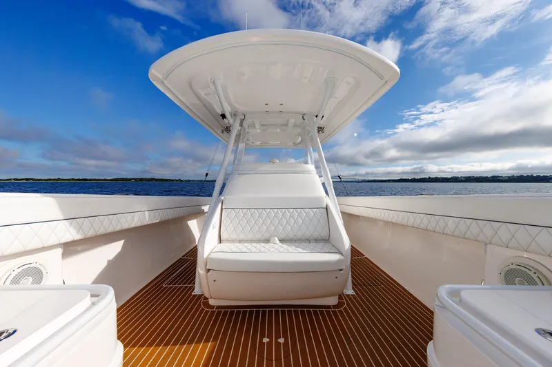 Slide: The Image of 2017 Intrepid 375 Nomad FE boat with white seating and blue sky background. - 52