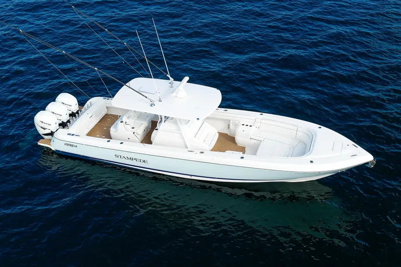 Slide: The Image of 2017 Intrepid 375 Nomad FE boat on open water, featuring triple outboard engines. - 8