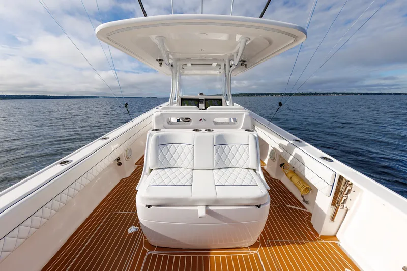 Slide: The Image of 2017 Intrepid 375 Nomad FE boat with white seating and wooden deck on open water. - 41