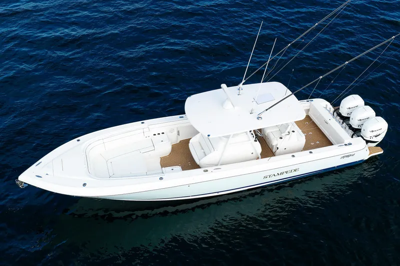 Slide: The Image of 2017 Intrepid 375 Nomad FE boat on open water, featuring triple outboard engines. - 11