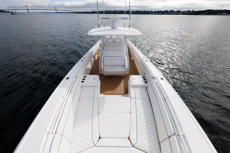 Slide: The Image of 2017 Intrepid 375 Nomad FE boat on calm water, featuring spacious seating and sleek design. - 61