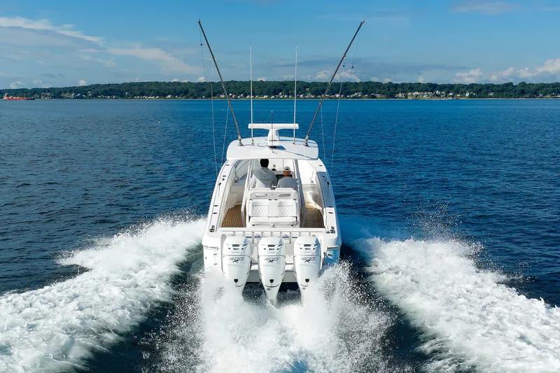 Slide: The Image of Intrepid 375 Nomad FE 2017 cruising on open water, rear view with triple engines. - 21