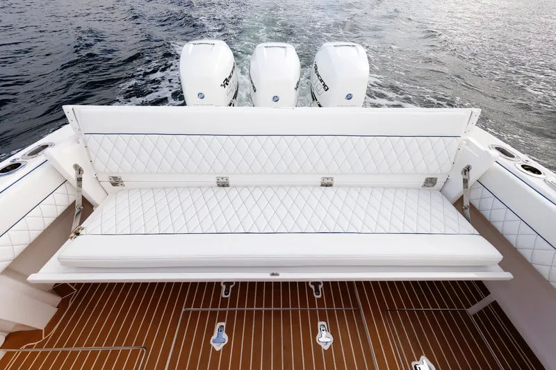 Slide: The Image of 2017 Intrepid 375 Nomad FE boat with white quilted seating and triple outboard engines. - 36