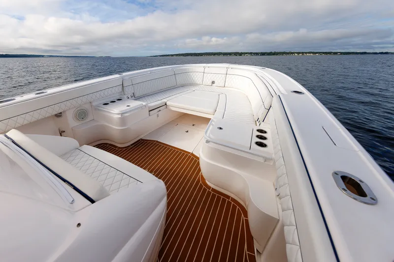 Slide: The Image of Luxurious 2017 Intrepid 375 Nomad FE boat interior with white seating and wooden deck. - 53