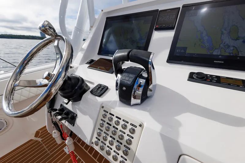 Slide: The Image of Control panel of 2017 Intrepid 375 Nomad FE boat with steering wheel and navigation screens. - 50