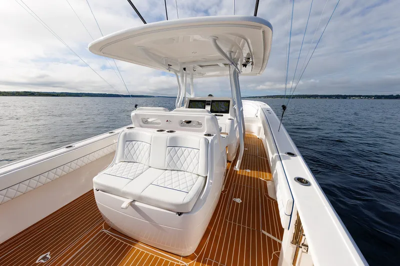 Slide: The Image of 2017 Intrepid 375 Nomad FE boat with sleek seating and modern design on open water. - 42