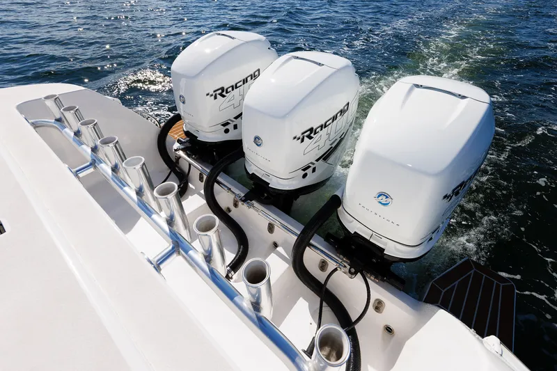 Slide: The Image of Triple outboard engines on a 2017 Intrepid 375 Nomad FE boat cruising on water. - 32
