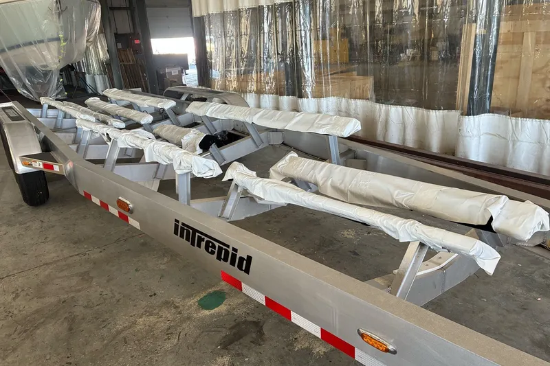 Slide: The Image of Trailer for 2017 Intrepid 375 Nomad FE boat in a warehouse setting. - 66