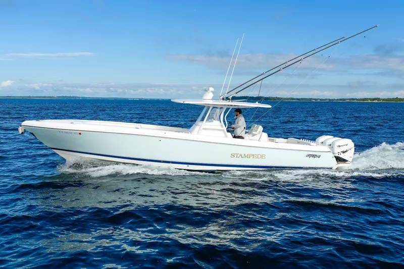 Slide: The Image of 2017 Intrepid 375 Nomad FE boat cruising on open water under clear skies. - 16