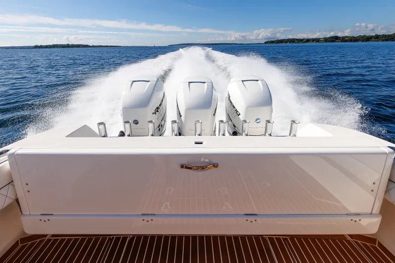 Slide: The Image of 2017 Intrepid 375 Nomad FE boat with triple engines cruising on open water. - 29