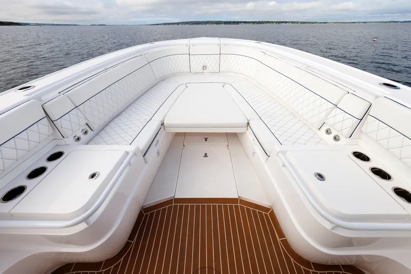 Slide: The Image of Luxurious seating area on 2017 Intrepid 375 Nomad FE boat, featuring elegant white upholstery. - 55