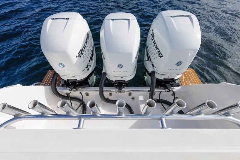 Slide: The Image of Triple outboard engines on a 2017 Intrepid 375 Nomad FE boat, with rod holders. - 31