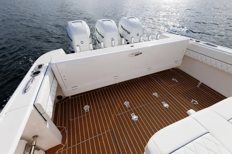 Slide: The Image of 2017 Intrepid 375 Nomad FE boat deck with triple outboard engines on water. - 33