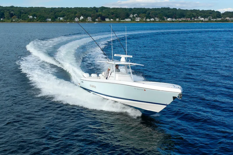 Slide: The Image of 2017 Intrepid 375 Nomad FE cruising on open water, creating a dynamic wake. - 25