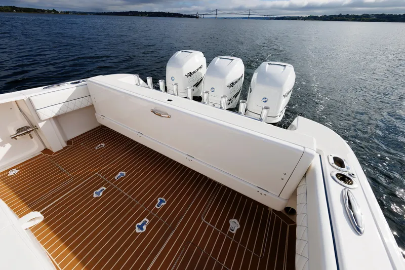 Slide: The Image of 2017 Intrepid 375 Nomad FE boat with triple outboard engines on calm water. - 37