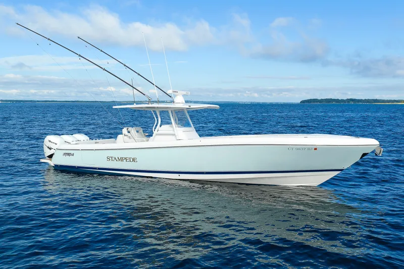Slide: The Image of 2017 Intrepid 375 Nomad FE boat on open water with fishing rods. - 6