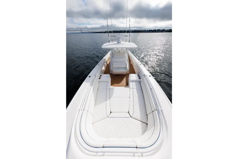 Slide: The Image of 2017 Intrepid 375 Nomad FE boat on calm water, featuring sleek white seating and modern design. - 59