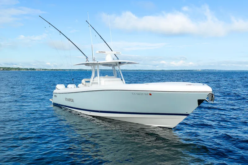 Slide: The Image of 2017 Intrepid 375 Nomad FE boat on open water, clear sky background. - 5