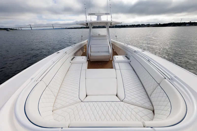 Slide: The Image of 2017 Intrepid 375 Nomad FE boat with luxurious white seating on calm water. - 58