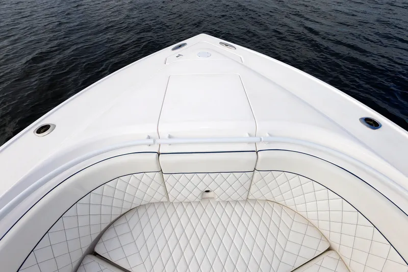 Slide: The Image of Bow seating area of 2017 Intrepid 375 Nomad FE boat on water. - 60
