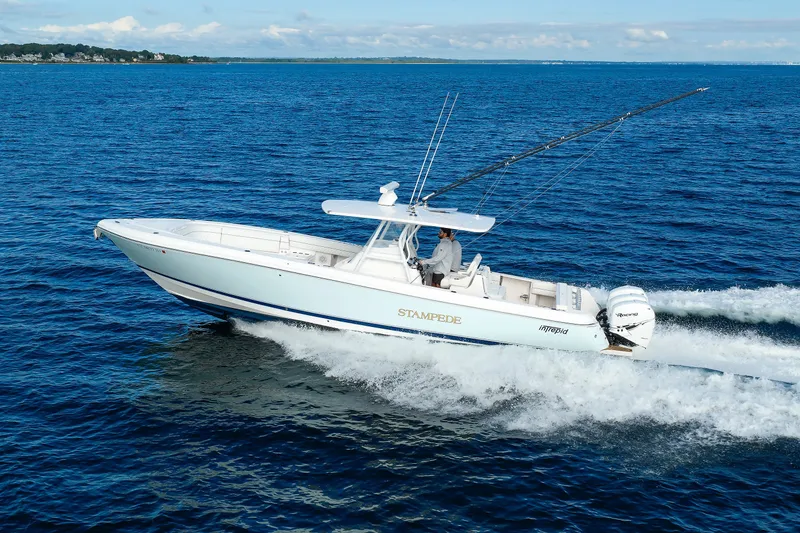 Slide: The Image of 2017 Intrepid 375 Nomad FE boat cruising on open water. - 17