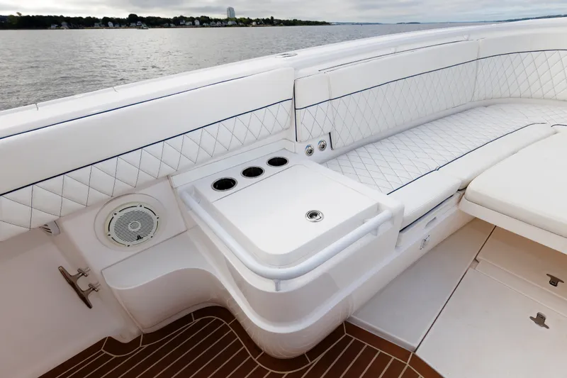 Slide: The Image of Luxurious seating area on a 2017 Intrepid 375 Nomad FE boat, featuring white upholstery. - 57