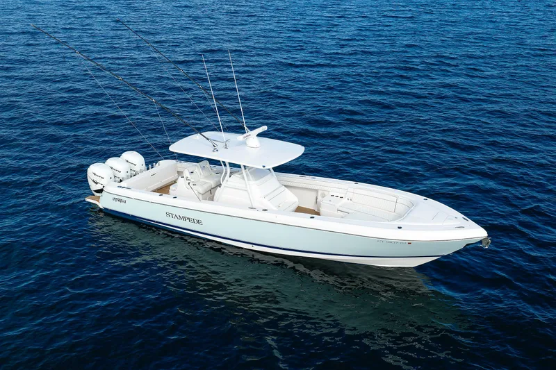 Slide: The Image of 2017 Intrepid 375 Nomad FE boat on open water, equipped with multiple outboard engines. - 7