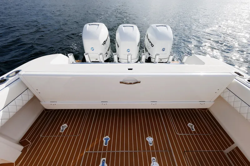 Slide: The Image of 2017 Intrepid 375 Nomad FE boat with triple outboard engines on water. - 35