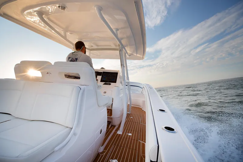 Slide: The Image of 2017 Intrepid 375 Nomad FE cruising on open water at sunset. - 10