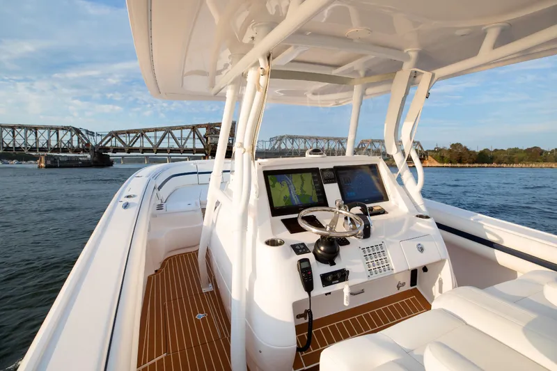 Slide: The Image of 2017 Intrepid 375 Nomad FE boat with advanced navigation system on open water. - 13