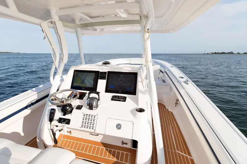 Slide: The Image of 2017 Intrepid 375 Nomad FE boat cockpit with navigation screens and steering wheel. - 14