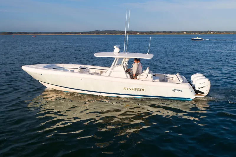 Slide: The Image of 2017 Intrepid 375 Nomad FE boat cruising on calm waters. - 3
