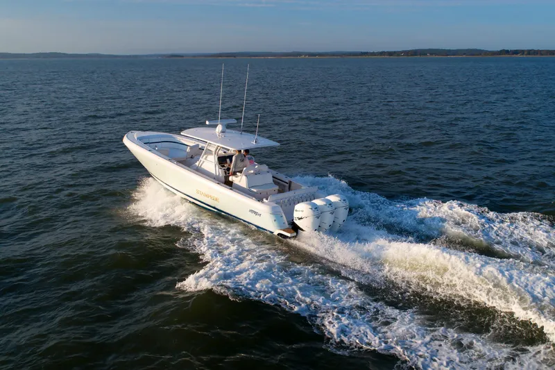 Slide: The Image of 2017 Intrepid 375 Nomad FE cruising on open water, showcasing powerful engines. - 7