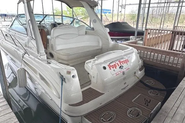 Slide: The Image of 2001 Sea Ray 340 Sundancer docked, showcasing spacious seating and elegant design. - 1