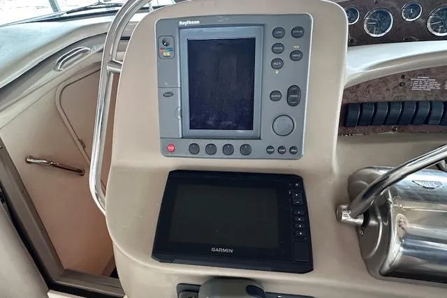 Slide: The Image of Control panel of a 2001 Sea Ray 340 Sundancer with Raytheon and Garmin displays. - 10