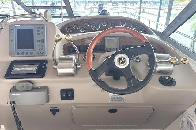 Slide: The Image of Helm of 2001 Sea Ray 340 Sundancer with steering wheel and navigation controls. - 15