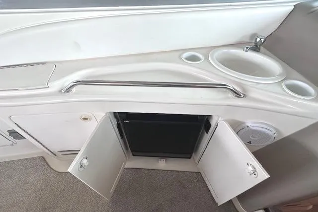 Slide: The Image of 2001 Sea Ray 340 Sundancer boat interior with sink, storage, and mini fridge. - 16