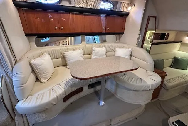 Slide: The Image of Interior of 2001 Sea Ray 340 Sundancer with plush seating and dining table. - 19