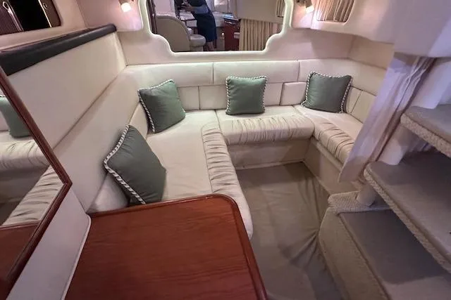 Slide: The Image of Interior of 2001 Sea Ray 340 Sundancer with beige seating and green cushions. - 20