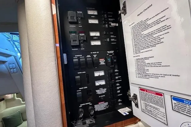 Slide: The Image of Electrical panel inside a 2001 Sea Ray 340 Sundancer boat cabin. - 22