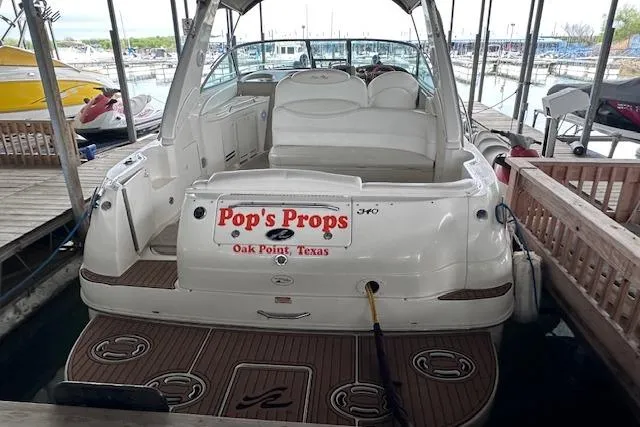 Slide: The Image of 2001 Sea Ray 340 Sundancer docked at marina, rear view with custom signage. - 3